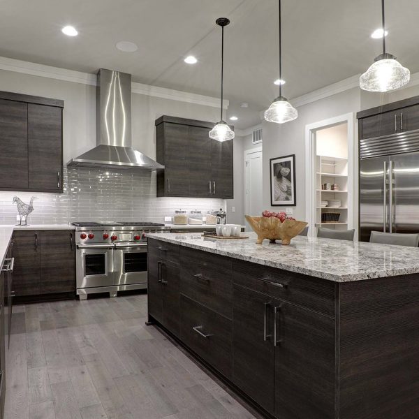 Modern gray kitchen features dark gray flat front cabinets paire